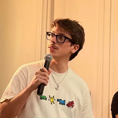 Ben Desprets holding a microphone, demoing an app on stage